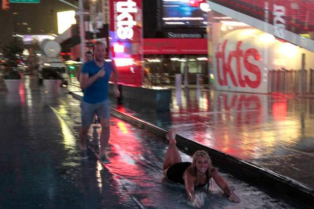 People in Times Square decide the bike lanes are obviously for Slip 'n Slide